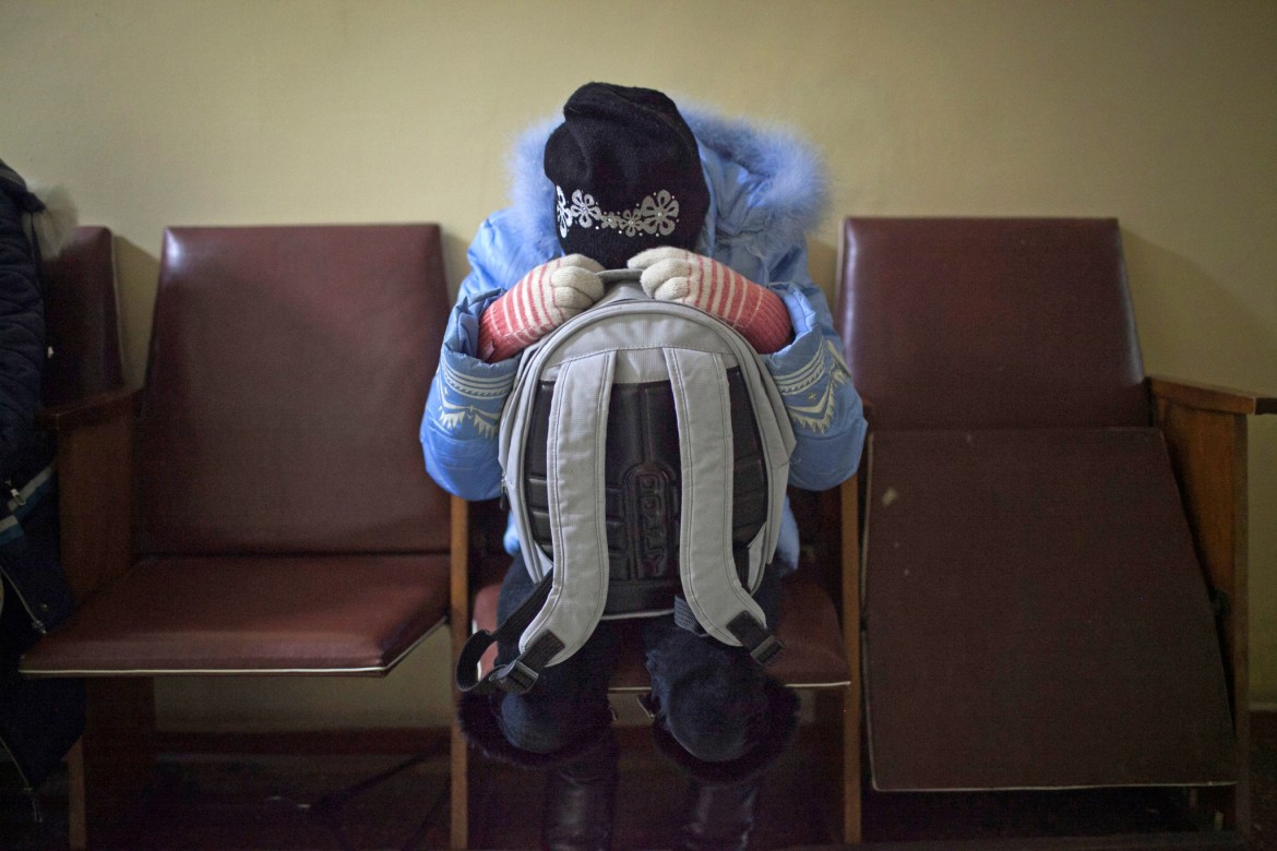 Donetsk, Ukraine, January 2015. A girl cowers in fear as shelling hits Hospital No. 3, which specializes in older people and children.