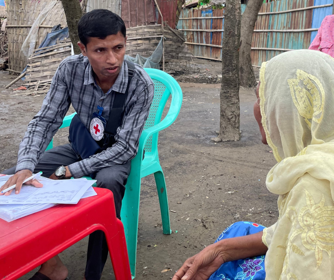 An ICRC staff from Sittwe explains our Restoring Family Links programme to Daw A. Photo: Oo Than TIN/ICRC