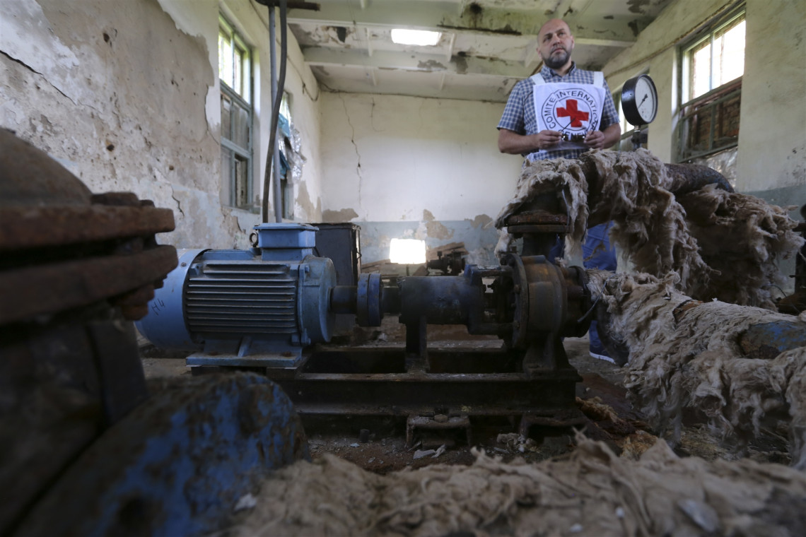Pervomaisk, Ukraine. An ICRC staff member evaluates the damages caused to a water pumping station. Photo: Stephanie XU/ICRC