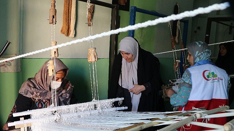  Women in Iran weave together to create various textiles for sale as part of an Empress Shoken Fund funded project, run by the Iranian Red Crescent Society, to support small businesses in rural communities. Photo: Iranian Red Crescent Society