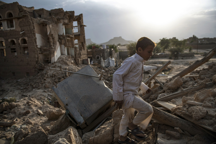 A boy runs through the rubble in the old city of Saada – Lynsey Addario/Getty Images