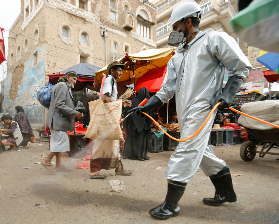 Sana’a, Yemen. A health worker disinfects a market street amid concerns over the spread of COVID-19, April 2020.